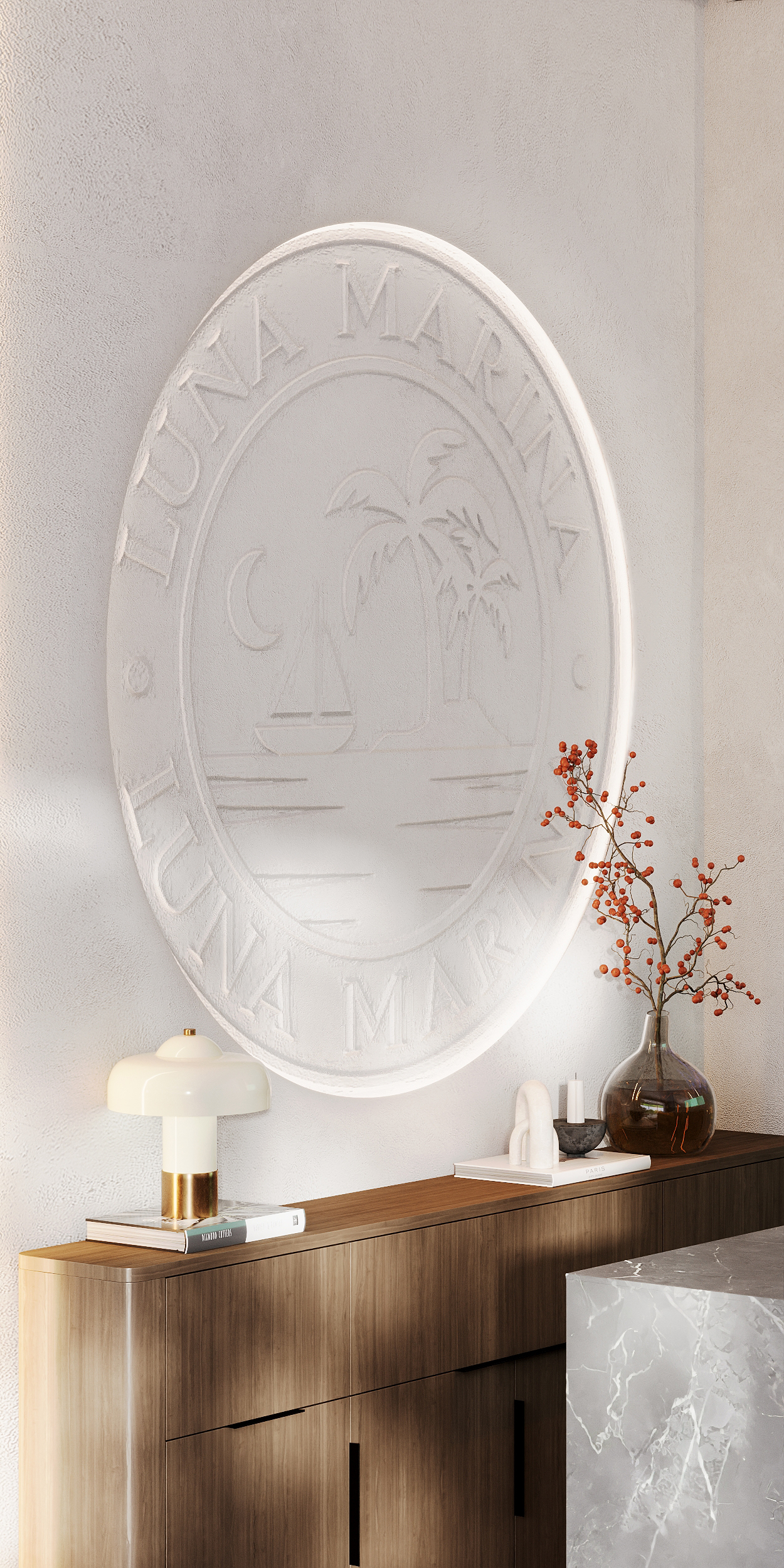 Embossed Luna Marina monogram on a plaster wall above a wooden console